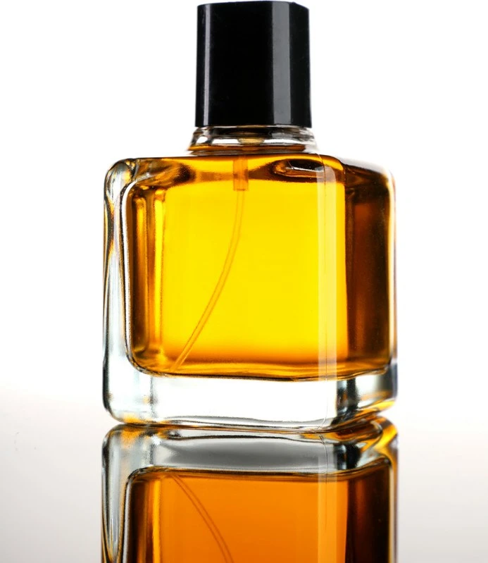 Perfume bottle with amber liquid in the original photo with its background