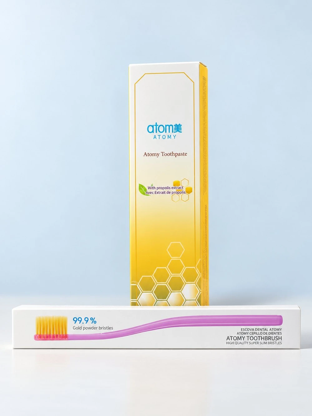 Retouched image of the toothpaste and toothbrush boxes on a clean light blue studio background